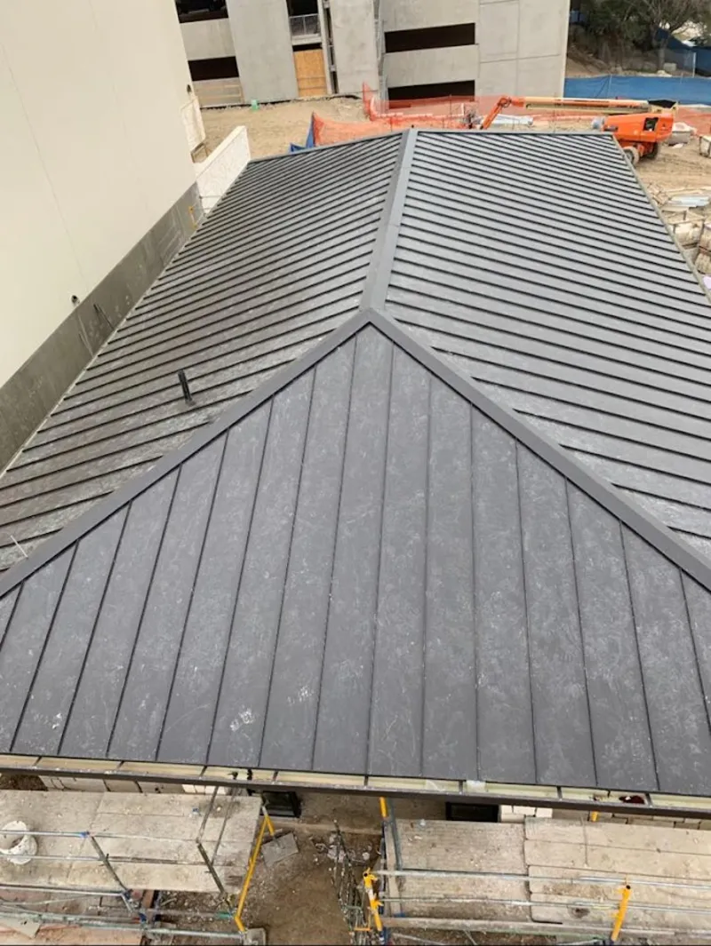 Commercial metal roof construction with crane equipment in Wynne